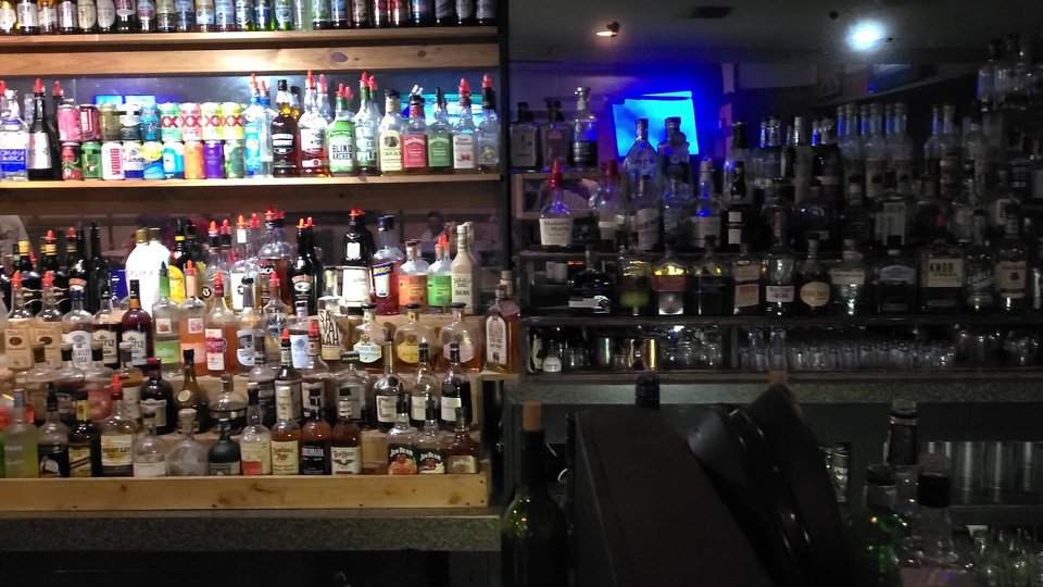 Lively restaurant interior with a warm, wood-toned bar.