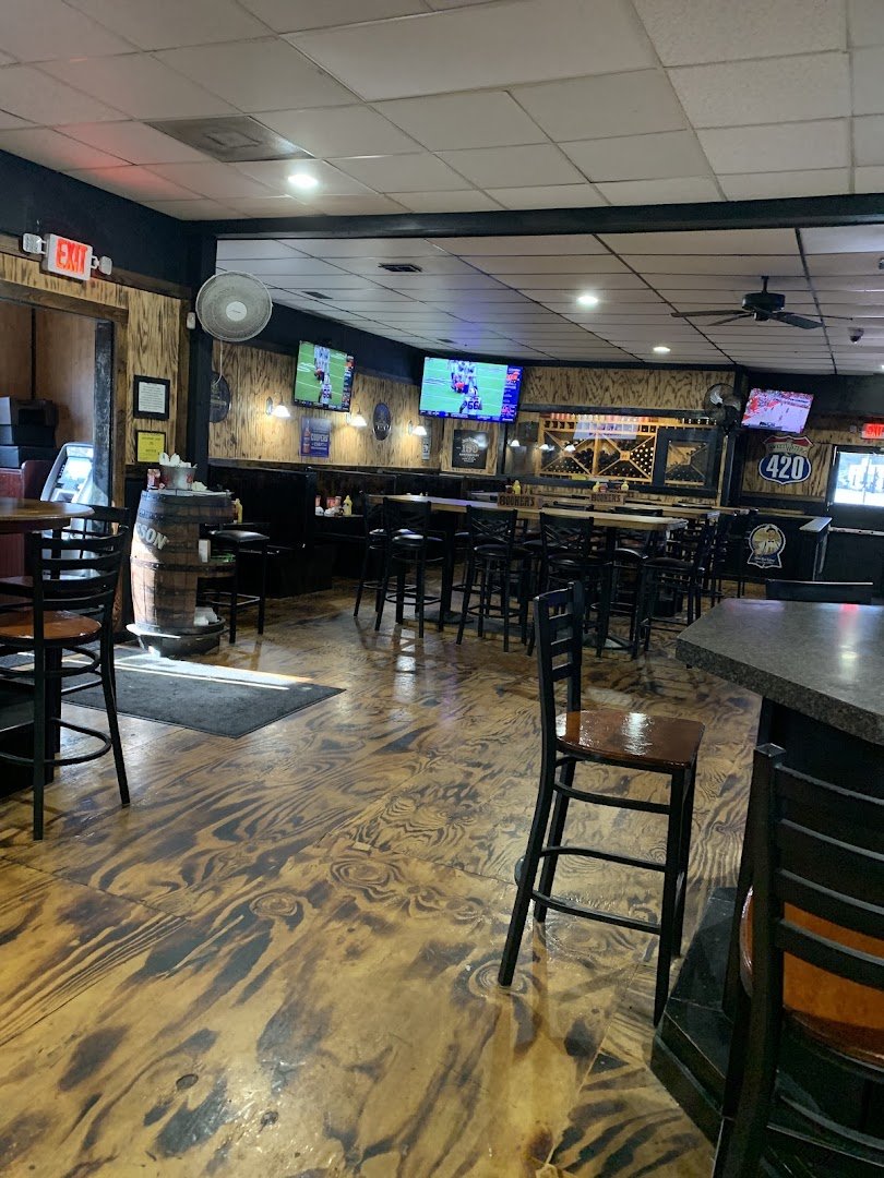 Lively restaurant interior with a warm, wood-toned bar.